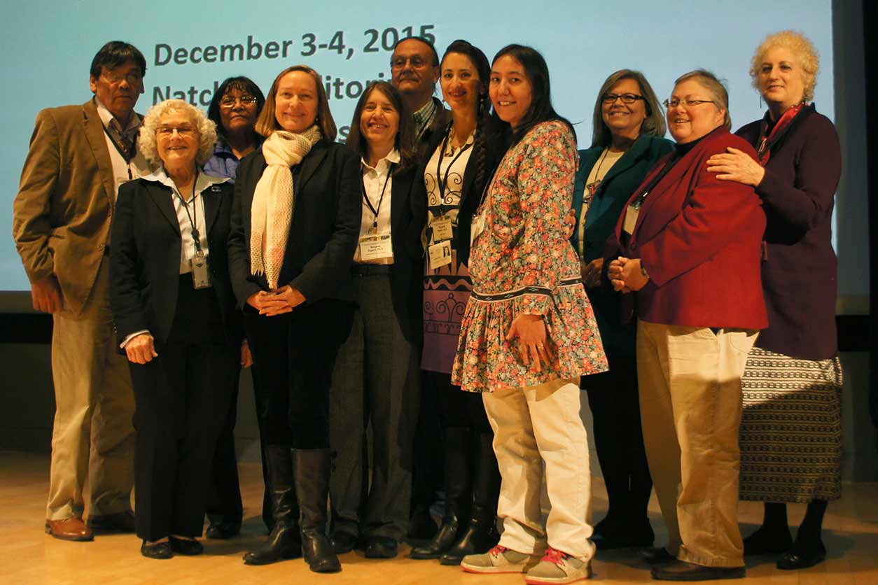 Members of the workshop planning committee, speakers, and attendees gathered for a photo on stage