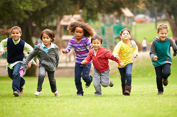 Children running through field