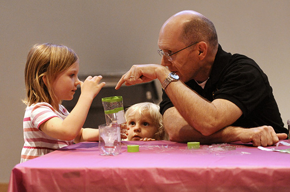 Mike Humble, Ph.D. teaching kids at a table