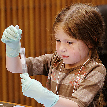 child playing with a test tube