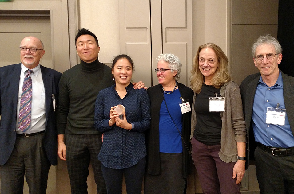 Kim, center, was congratulated by, from left, Suk; her husband, Hyun Kim; the center’s Research Translation Core leader Wendy Heiger-Bernays, Ph.D.; the center’s Training Core co-leader Jean van Seventer, V.M.D; and the center Director David Sherr, Ph.D.
