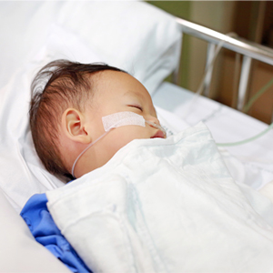 sick infant in a hospital bed
