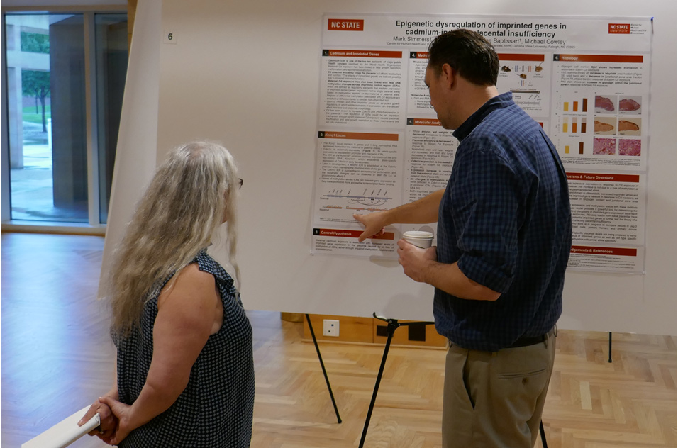 Carol Swartz, D.V.M., Ph.D. and Mark Simmers viewing a poster on cadmium toxicity