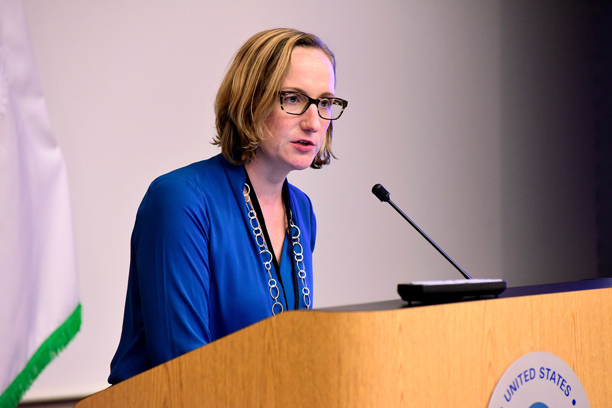 Laura Thomas, Ph.D. at podium