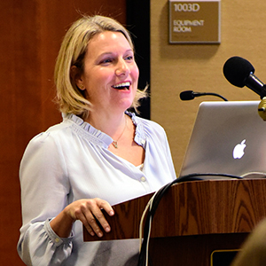 Karen Parker, Ph.D. speaking at a podium
