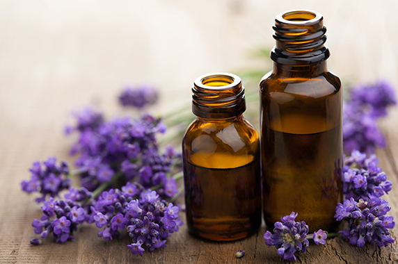 Lavender flowers and brown glass bottles of lavender oil