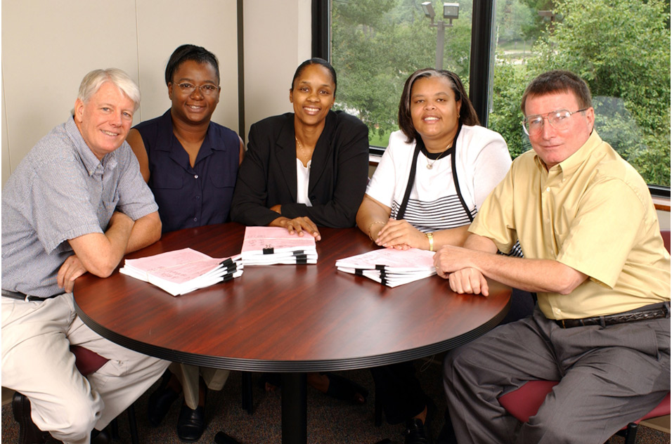 people in the WTP program in 2004 sit around a table