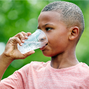 boy drinking a cup of water