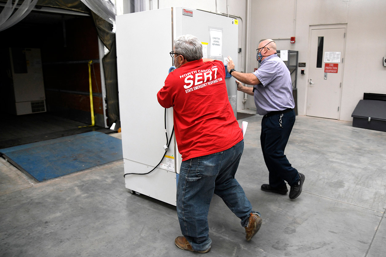 David Mills and Rick Weaver move a freezer