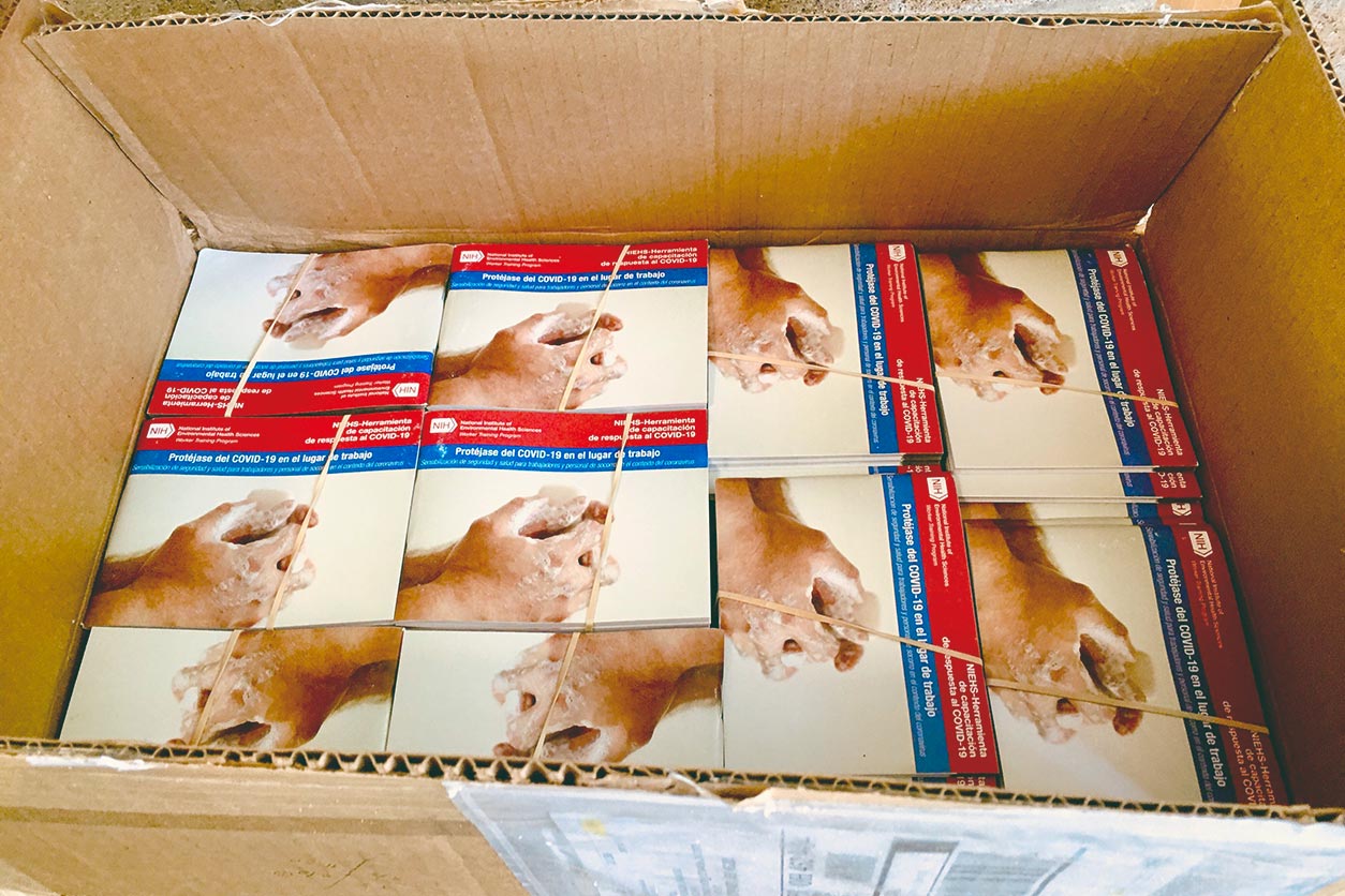 an open box of NIEHS Protecting Yourself from COVID-19 in the Workplace booklets