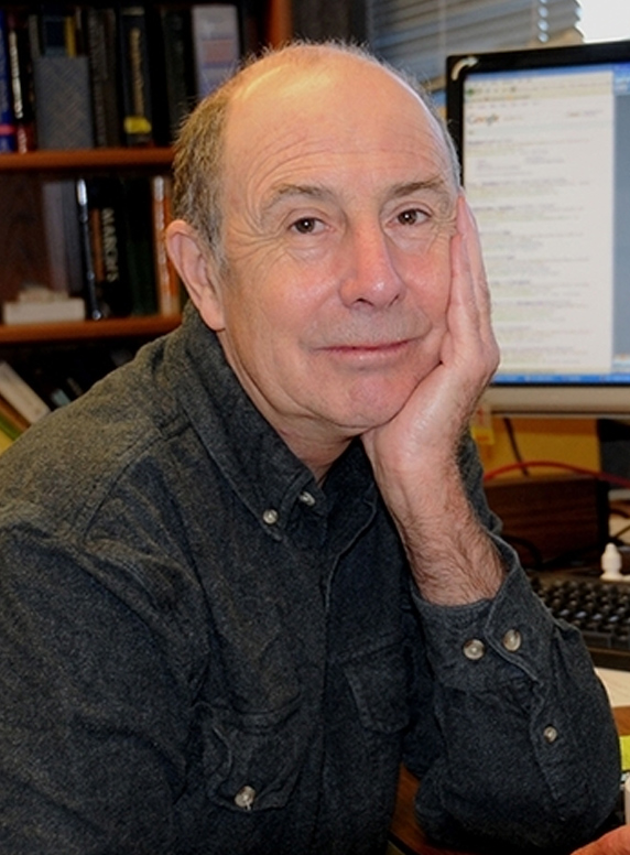 Bruce Hammock seated at a desk