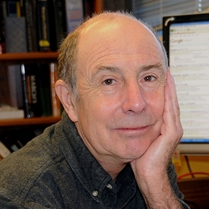 Bruce Hammock seated at a desk
