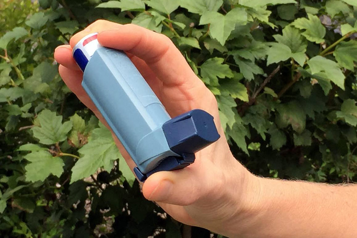 hand holding asthma inhaler