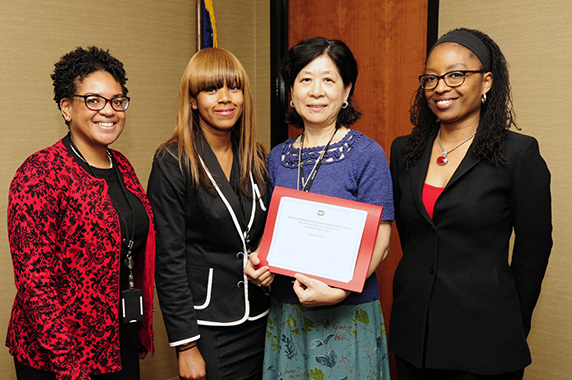 Alanna Burwell presents a certificate of appreciation to Yu