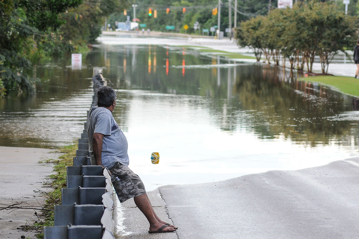 A resident of Wilmington, NC, surveys the flood waters following Hurricane Florence.