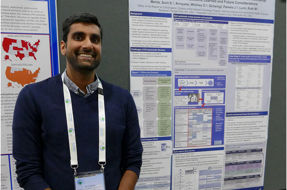 Suril Mehta stands next to the poster he presented