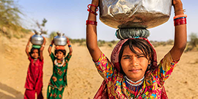Global Environmental Health Chat Image - Girl carrying a water container
