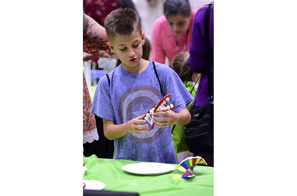 boy with hands-on DNA model