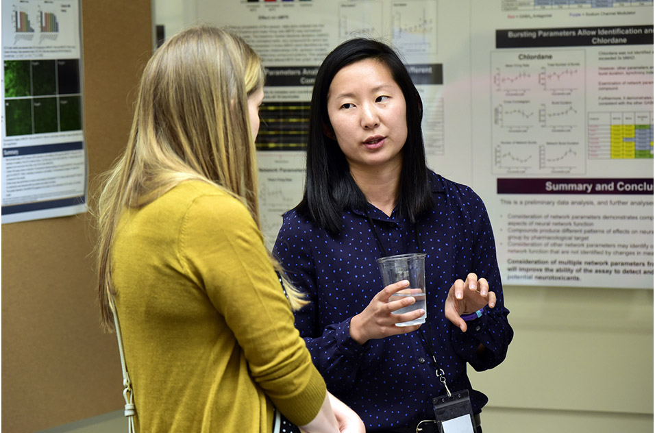 Mimi Huang, Ph.D. speaking with an attendee