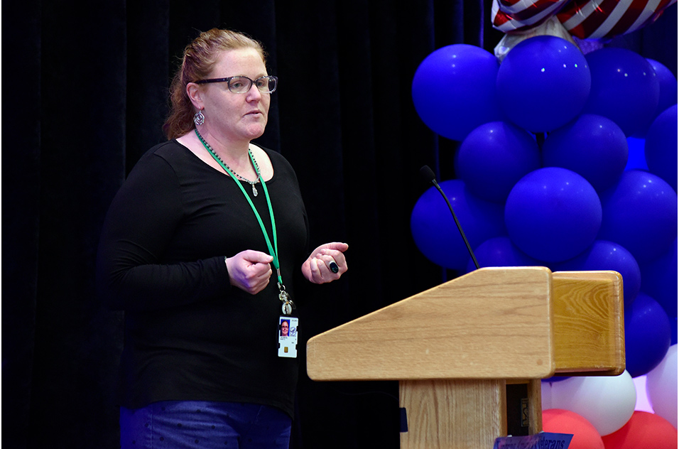 Mary Jacobson at podium of NIEHS Veterans Day Celebration