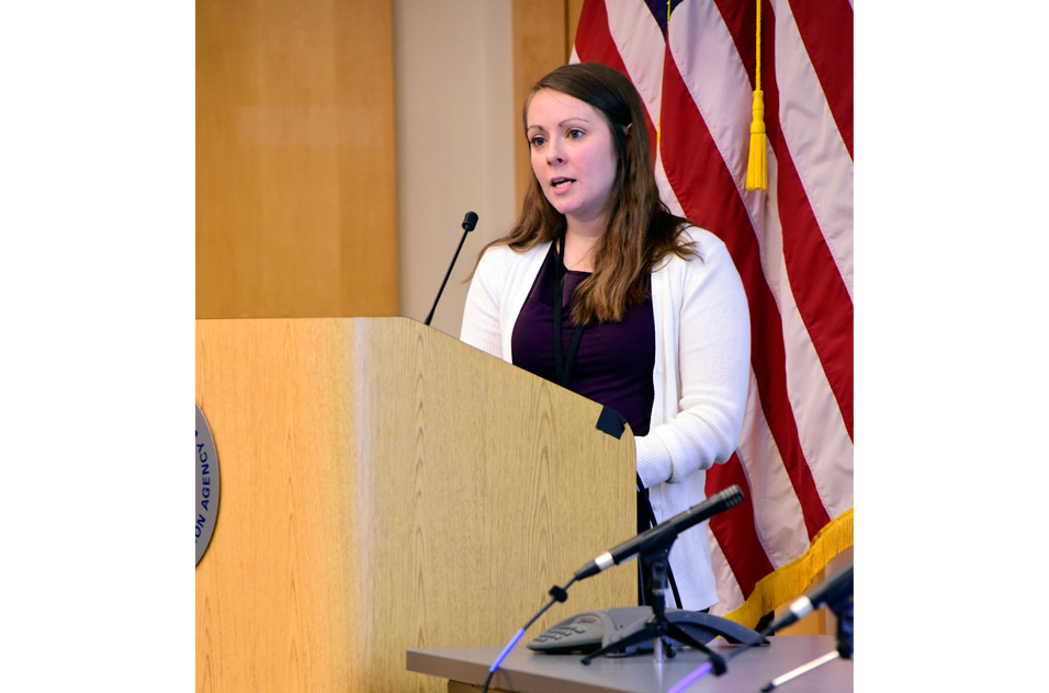 Laura Bisogno, Ph.D. stands at podium