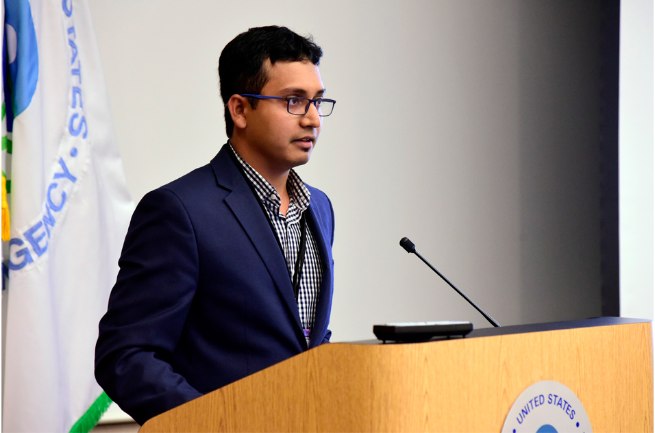 Arif Rahman, Ph.D. stands at podium