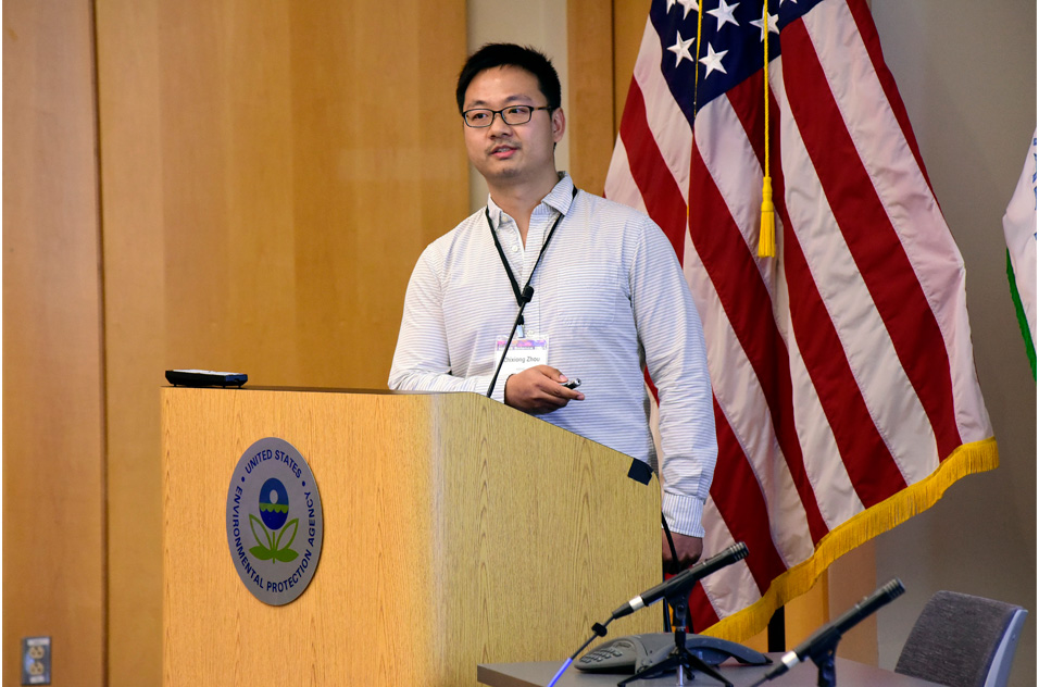 Zhixiong Zhou, Ph.D. stands at podium