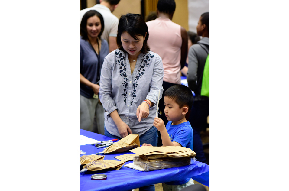 Woman and boy build a paper bag lung