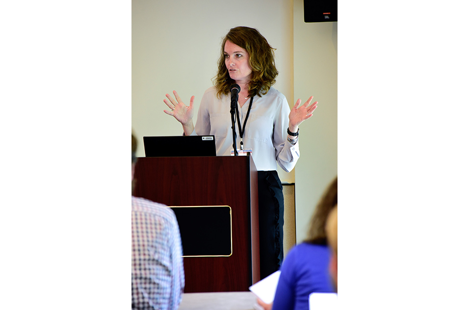 Erin Haynes speaking at the podium during the event