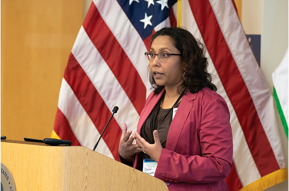 Sharlini Sankaran speaking at the podium