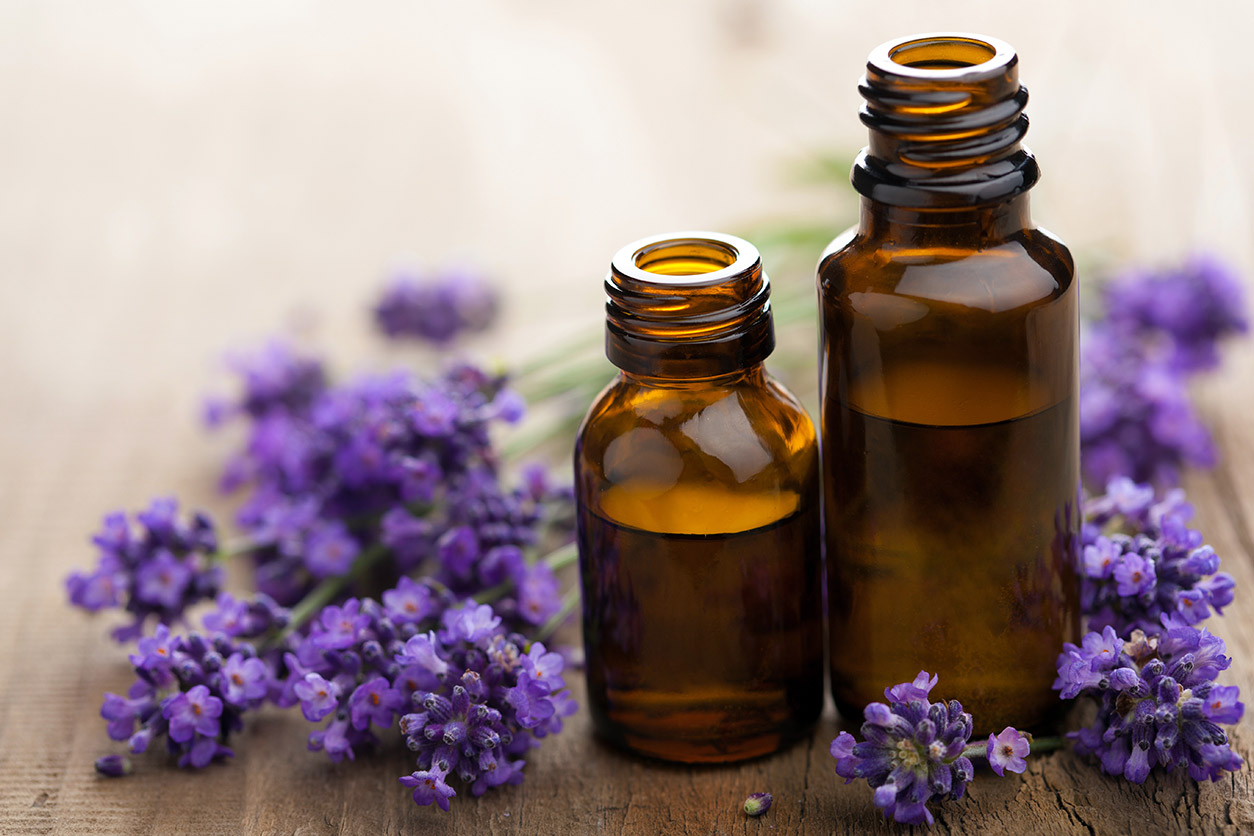 Lavender flowers and brown glass bottles of lavender oil