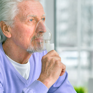 older person using an inhaler
