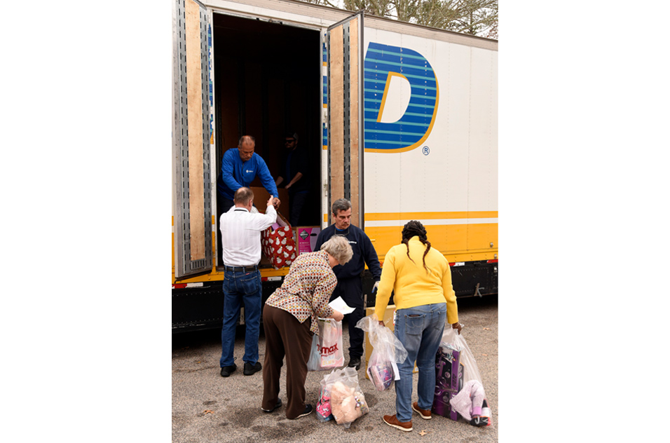 volunteers loading a truck with gifts