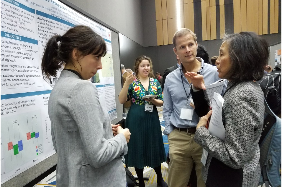 trainees talk during poster presentation