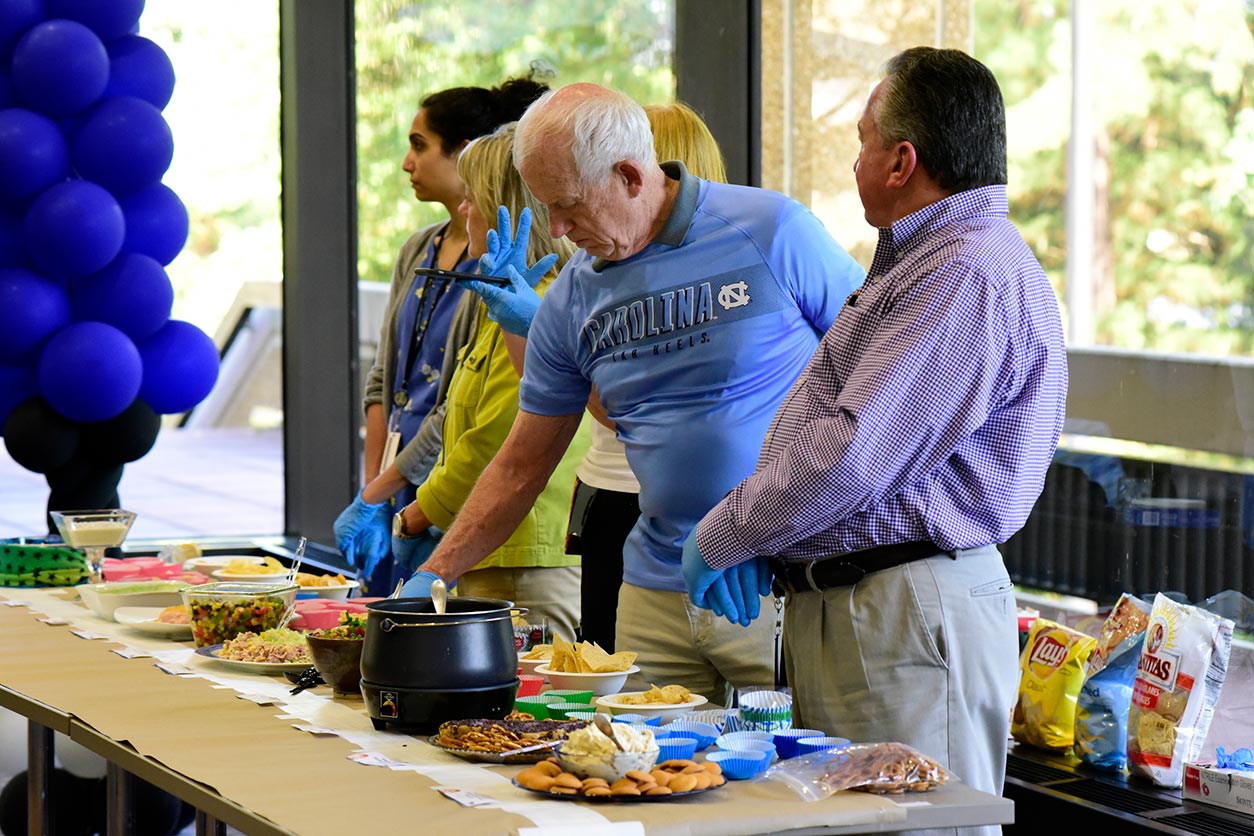 Volunteers working at food tables at event