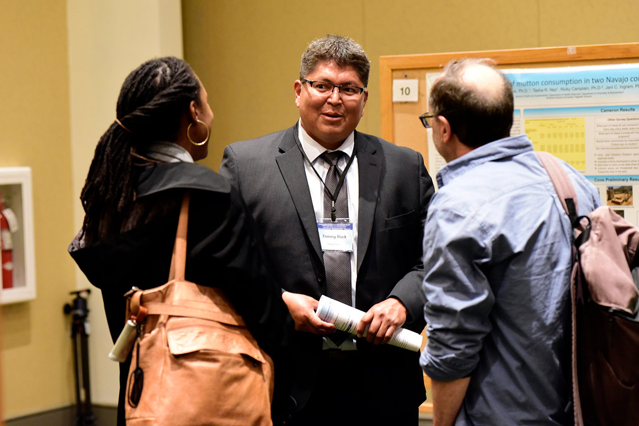 Tommy Rock, Ph.D. speaks with other attendees