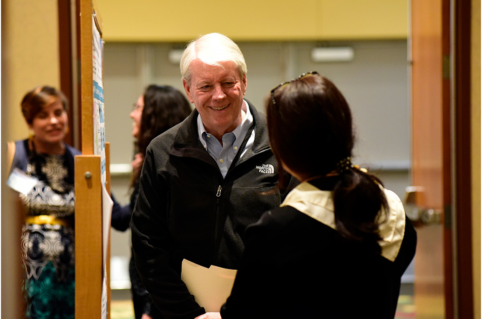 Joseph “Chip” Hughes smiles at attendee