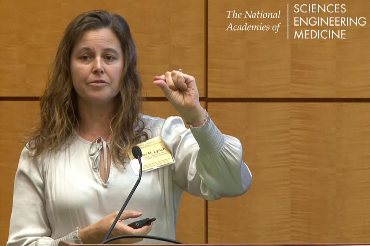 Jennifer Lynch, Ph.D. stands at podium