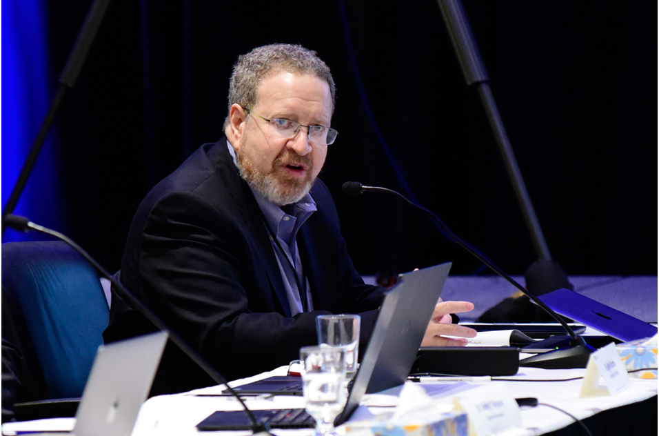 Kenneth Fasman, Ph.D. seated at table