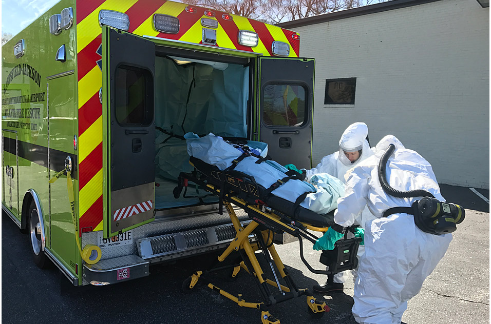 emergency medical responders receive training by an ambulance