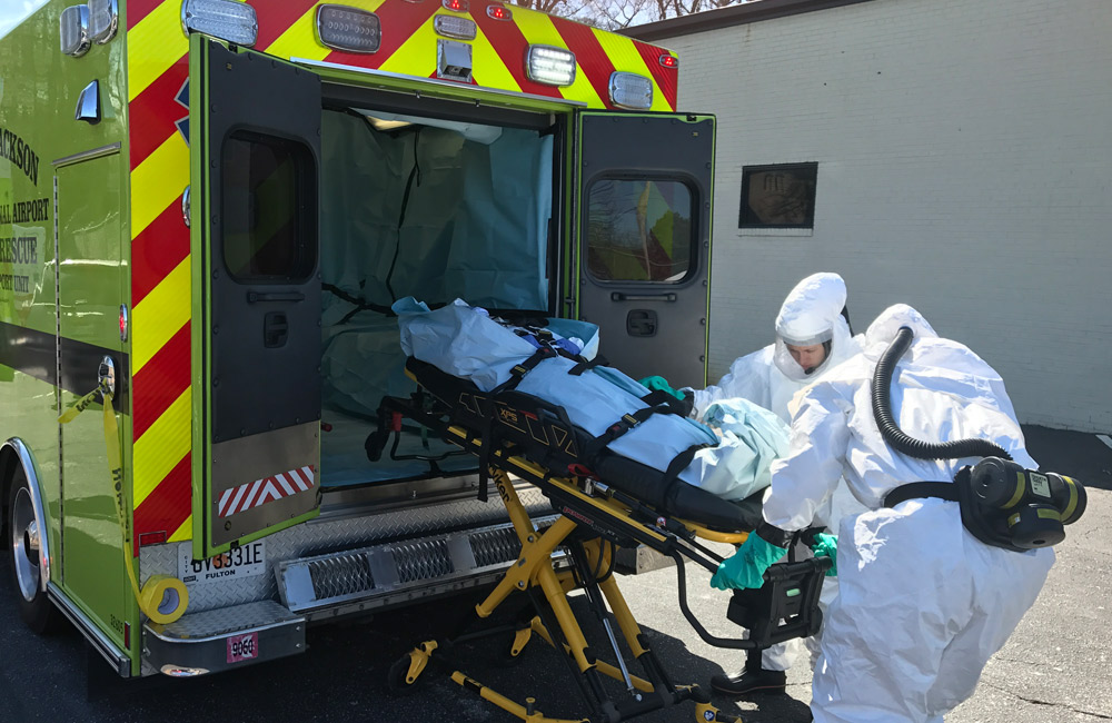 emergency medical responders receive training by an ambulance