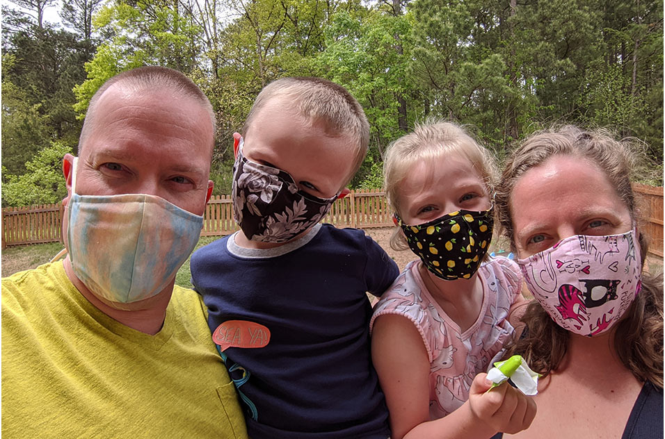 Whitney Murphy with 2 her children and husband, Jimmy Murphy in masks