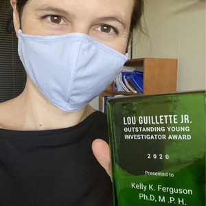 Kelly Ferguson, Ph.D. holds her Lou Guillette, Jr. Outstanding Young Investigator Award