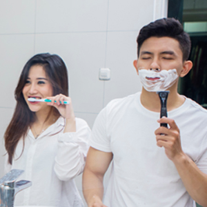 two people, shaving and brushing teeth