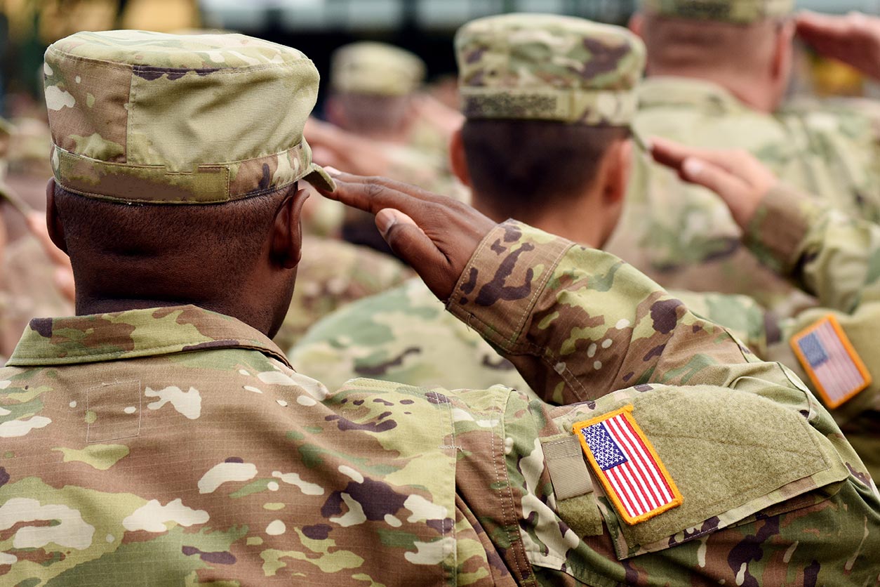 saluting military men, facing away