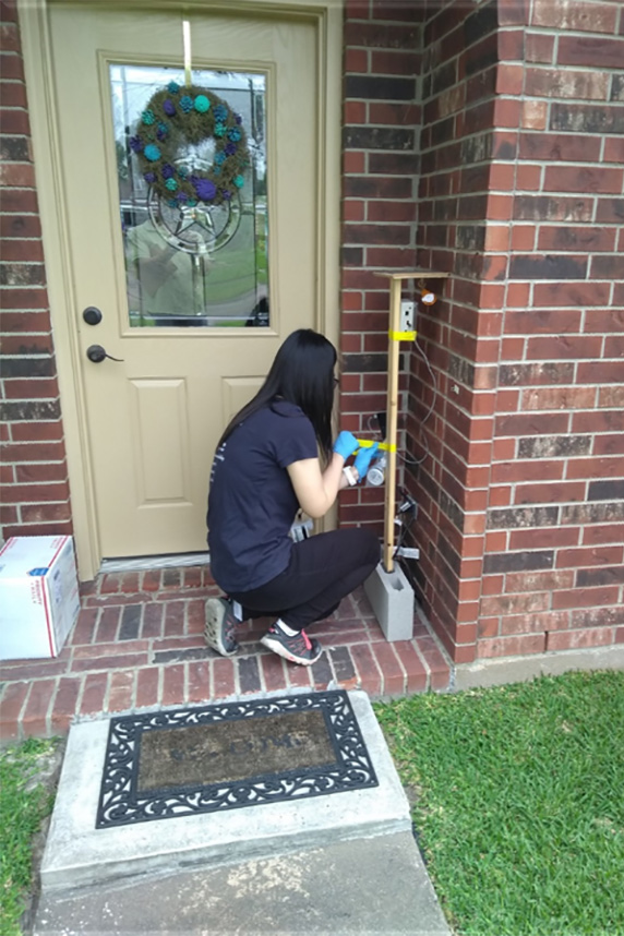 Tsai-Shu Chu working outside a house in Texas