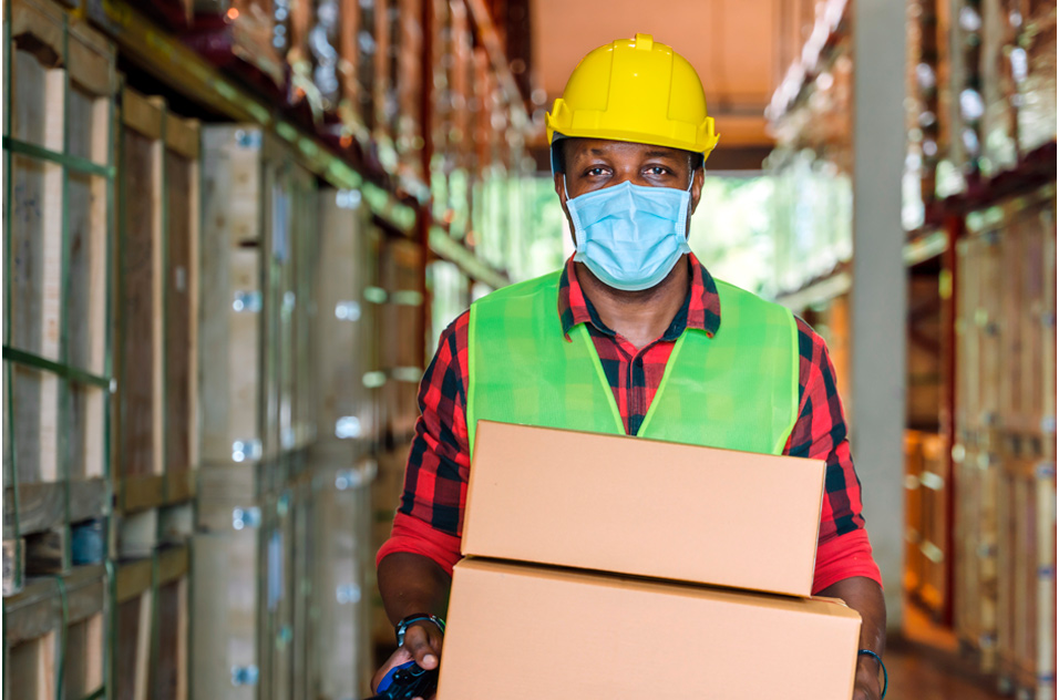 man holding boxes in a warehouse