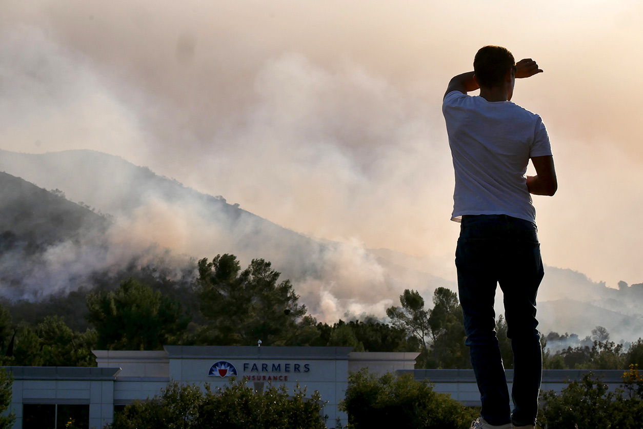 smoke billowing from 2018 wildfire in California as person looks onward