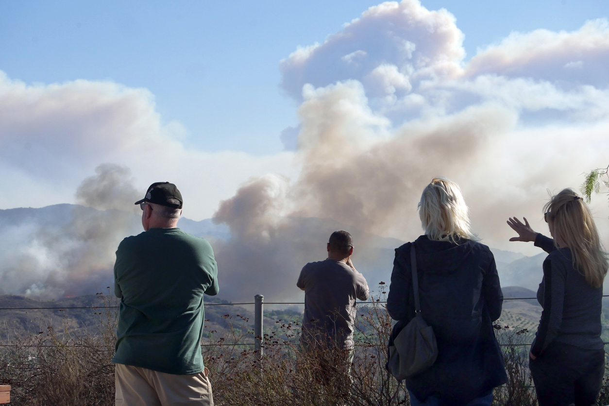 people viewing the smoke from wildfires in the distance