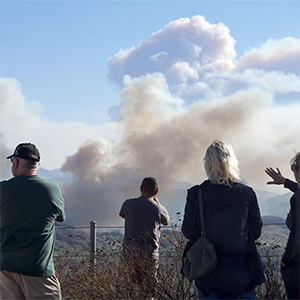 people viewing the smoke from wildfires in the distance